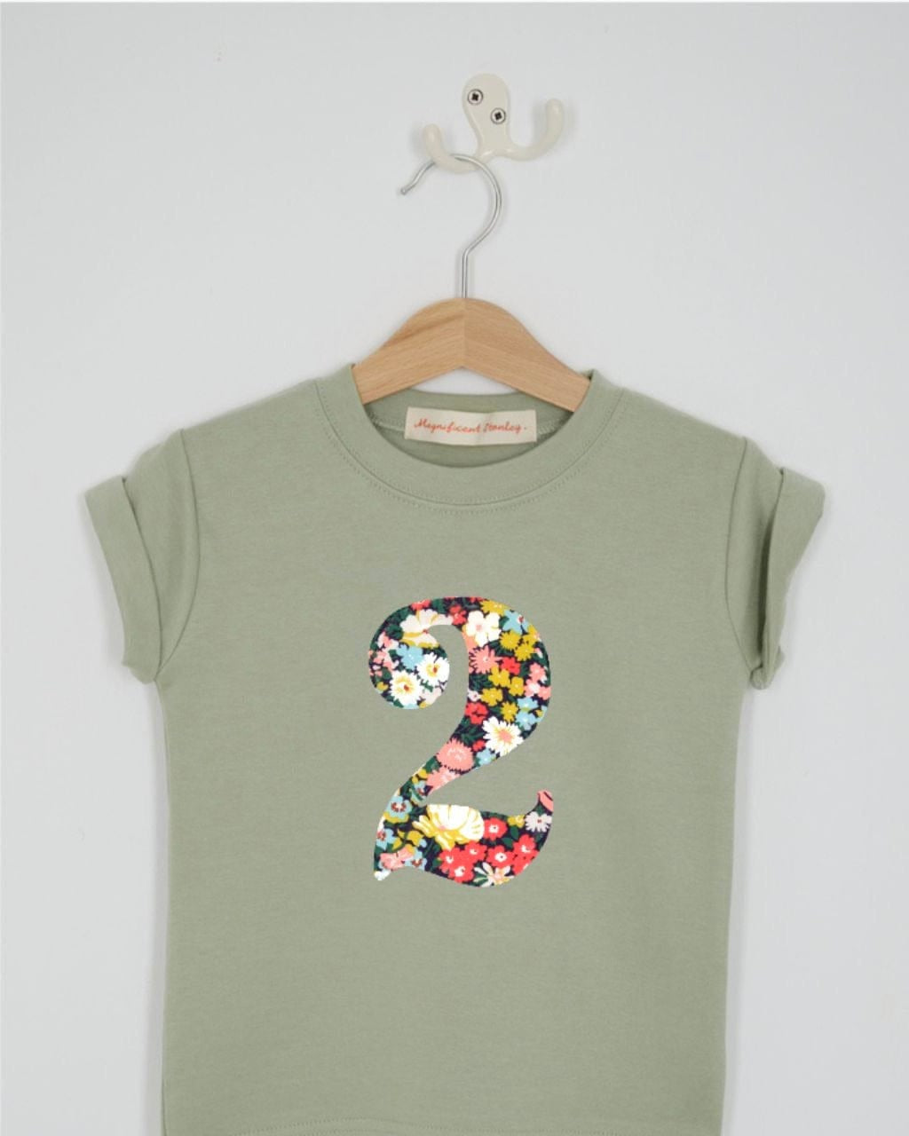 a number 2nd birthday kids sage green t-shirt with a number cut from thorpe floral liberty print on the front.