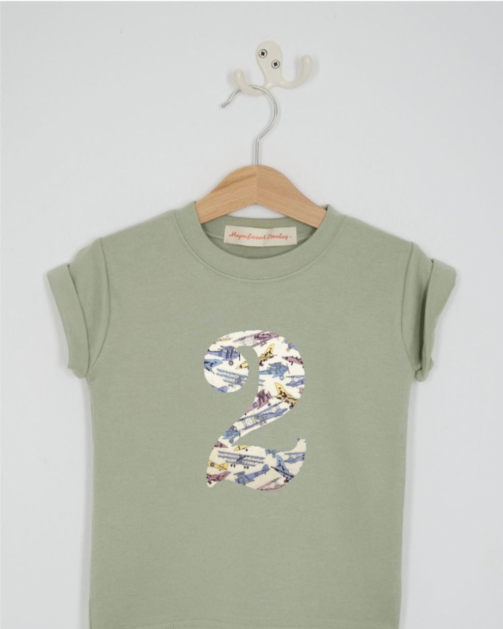 a number 2nd birthday kids sage green t-shirt with a number cut from tom's jet vintage plane liberty print on the front.
