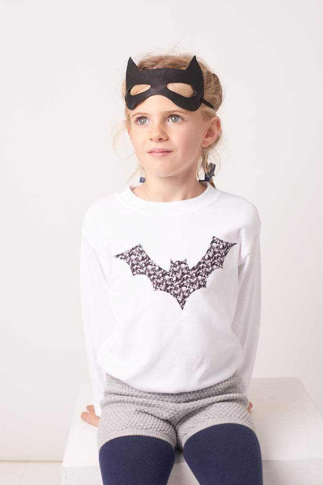 A girl in white cotton tee with a bat on made from Liberty Alba print fabric for halloween.