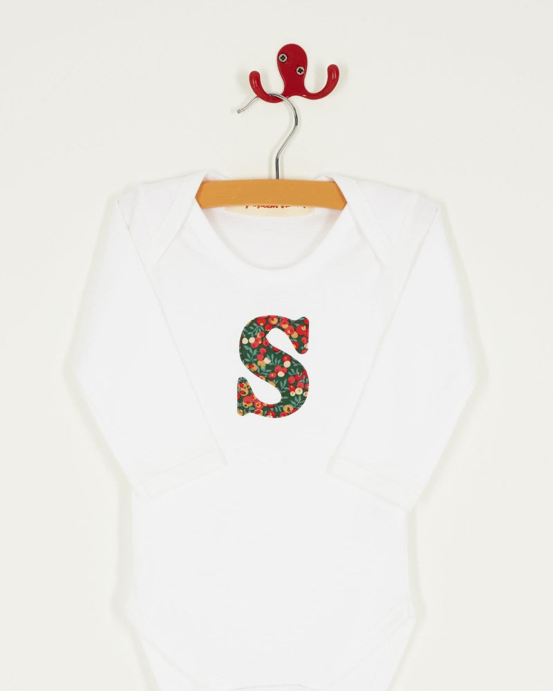 A personalised initial Magnificent Stanley baby Bodysuit in Glitter Wiltshire Liberty Print