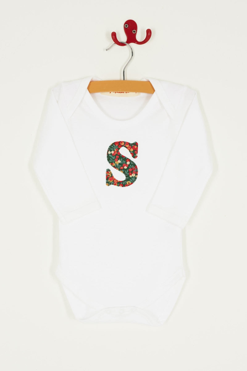 A personalised initial Magnificent Stanley baby Bodysuit in Glitter Wiltshire Liberty Print