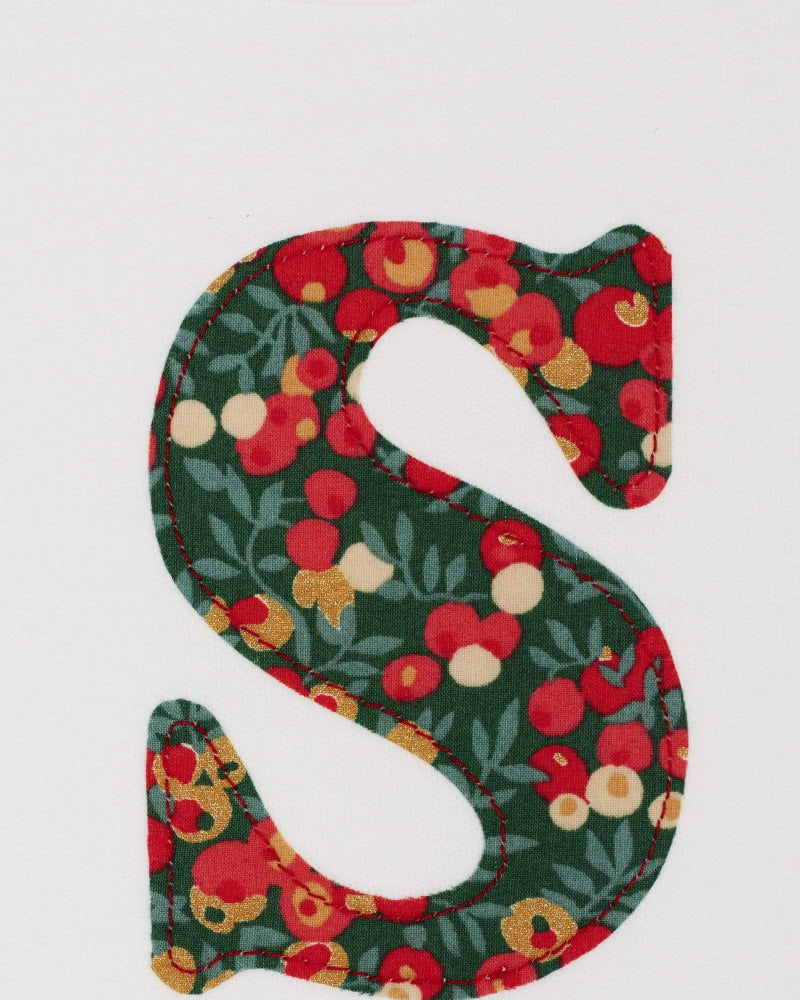 Close up of a personalised initial on a Magnificent Stanley Bodysuit in Glitter Wiltshire Liberty Print