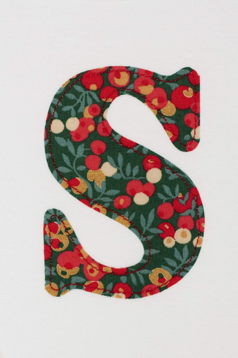 Close up of a personalised initial on a Magnificent Stanley Bodysuit in Glitter Wiltshire Liberty Print