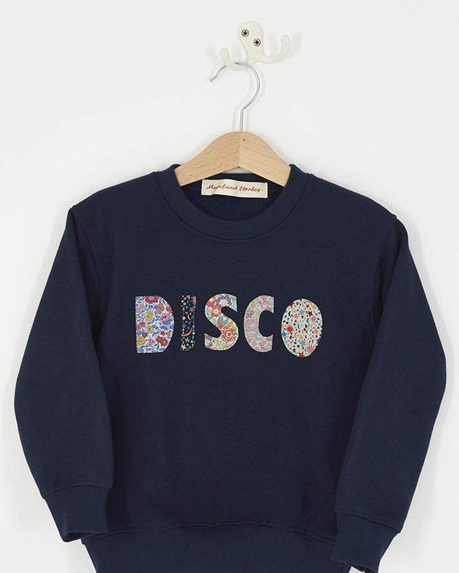 a Magnificent Stanley navy sweatshirt with the word DISCO Mixed Liberty Print sewn onto the front