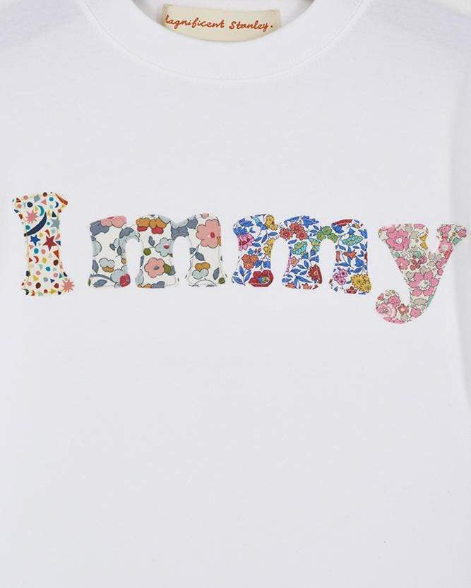 A close up of a personalised white t-shirt with her name on in a mix of Liberty prints.