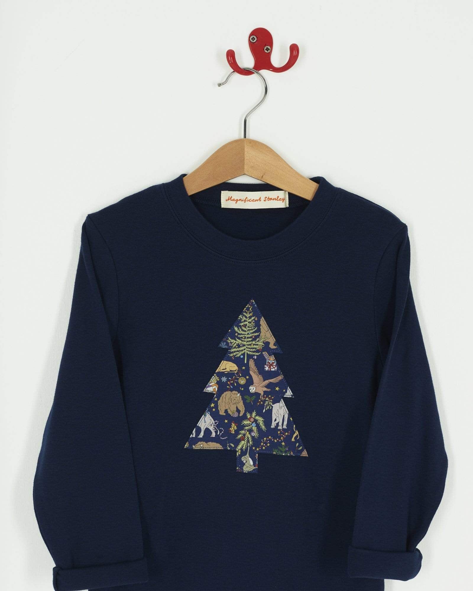 A navy long sleeve Christmas t-shirt with a Christmas Tree on the front made from Liberty Christmas print .