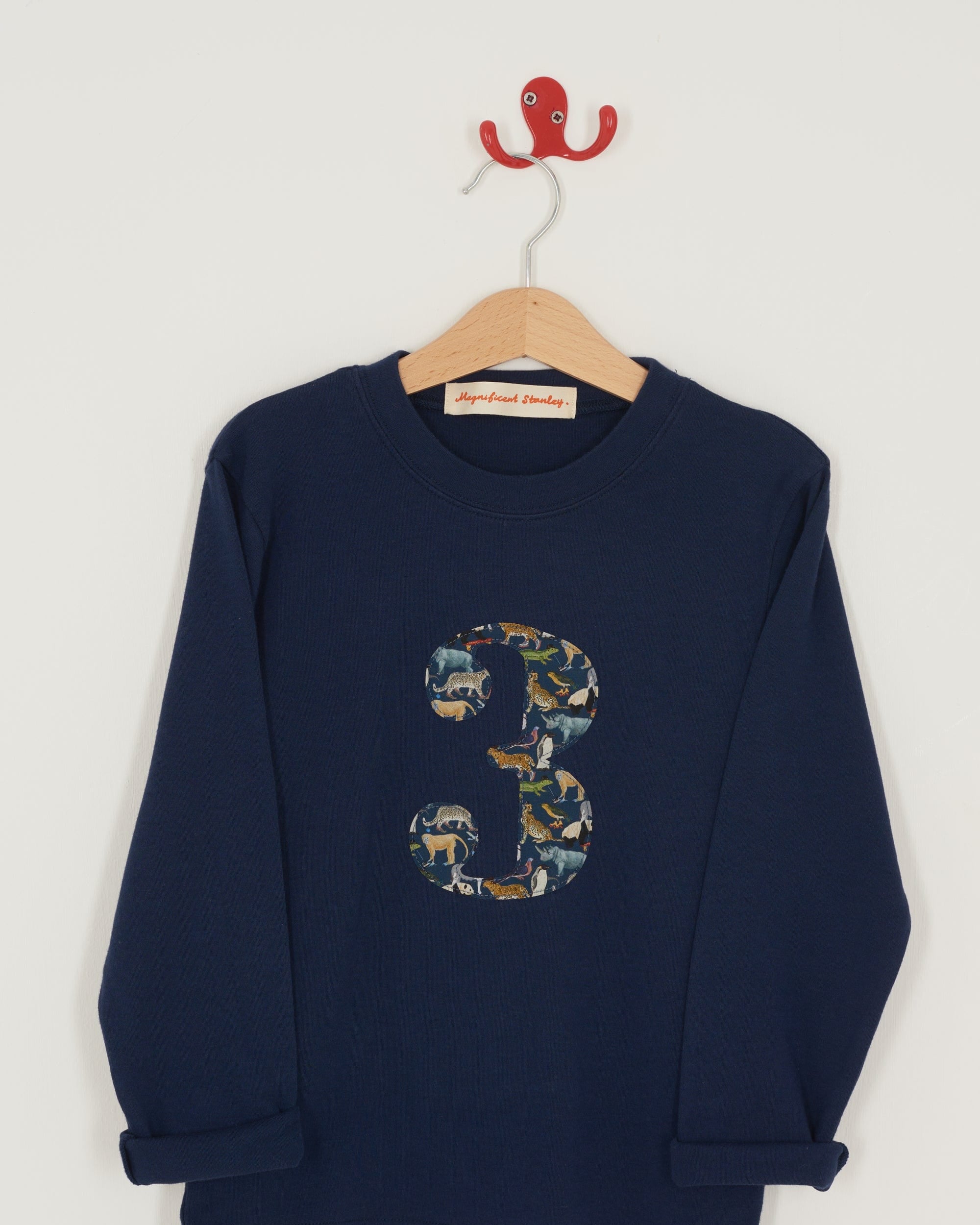 A navy long sleeve t-shirt with a  number 3 on the front on in Liberty Quey Zoo animal print fabric.