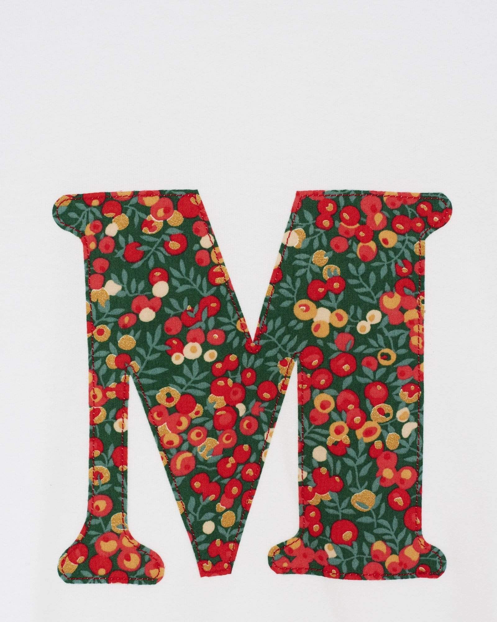 A personalised white t-shirt with a her initial on the front made from Liberty Glitter Wiltshire berry fabric.