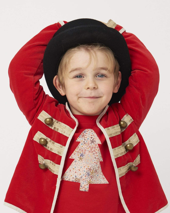 a 5 year old boy wearing a Magnificent Stanley Tee Red Tree kids Christmas T-Shirt in Adelajda Liberty Print