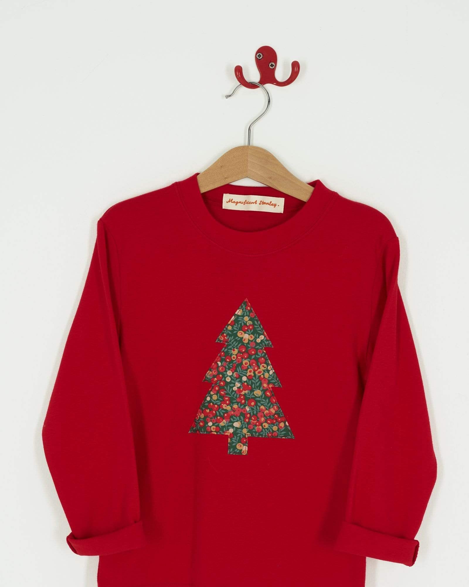A festive red t-shirt with a Christmas tree on the front made from Liberty Glitter Wiltshire berry fabric.