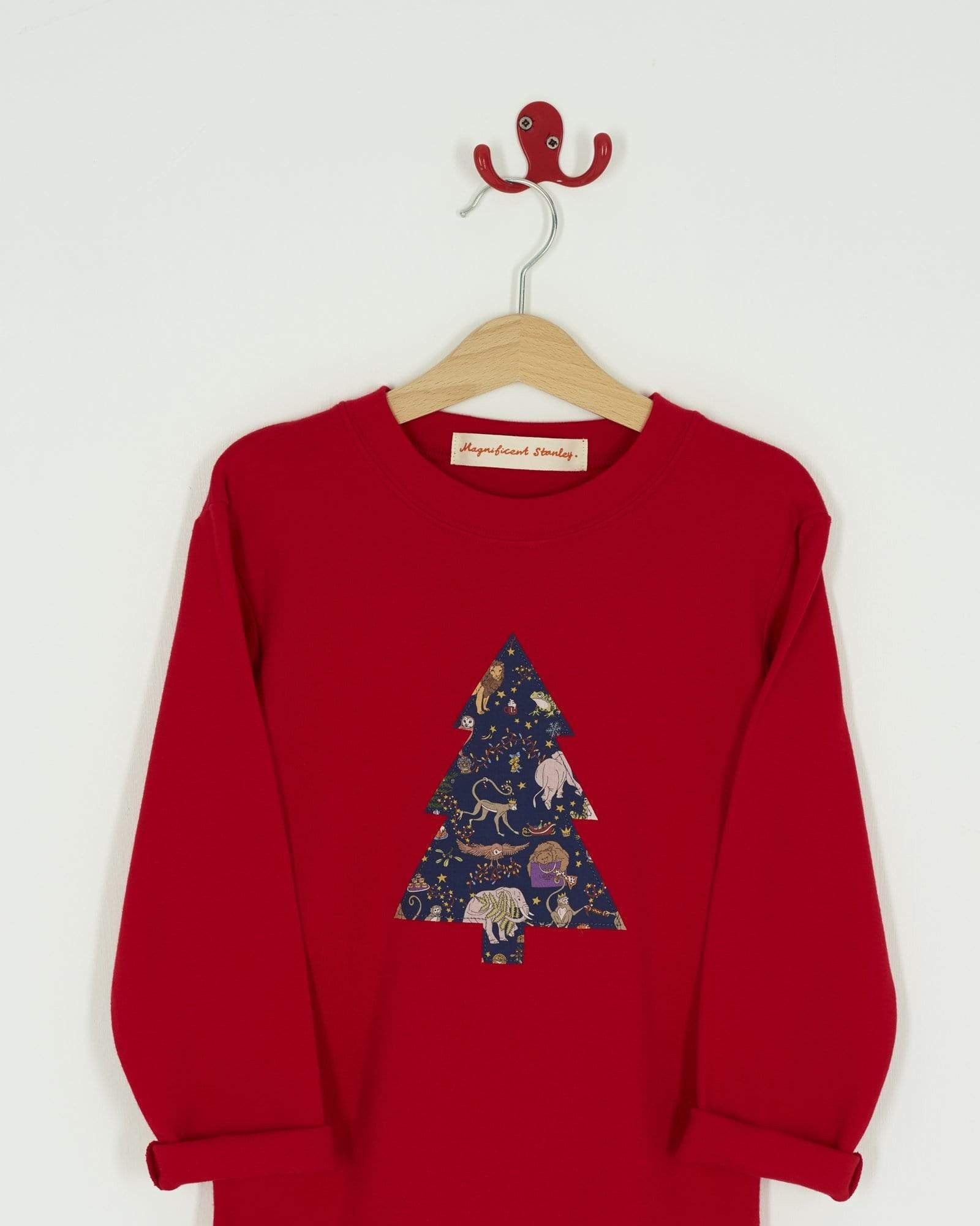 A festive red t-shirt with a christmas tree on the front made from Liberty Christmas fabric.
