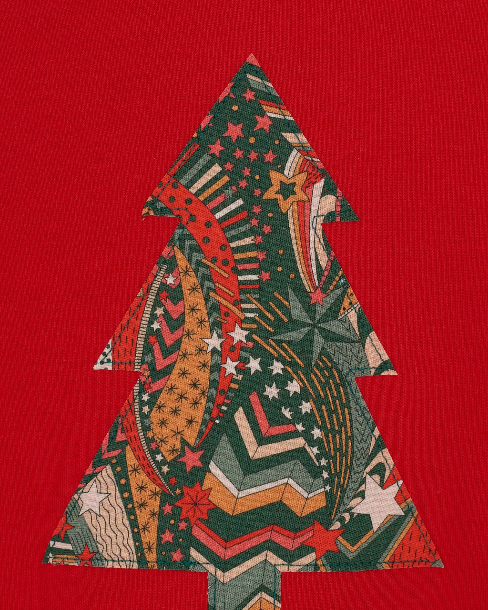 A festive red cotton t-shirt with a Christmas tree made from a stray liberty print on the front.