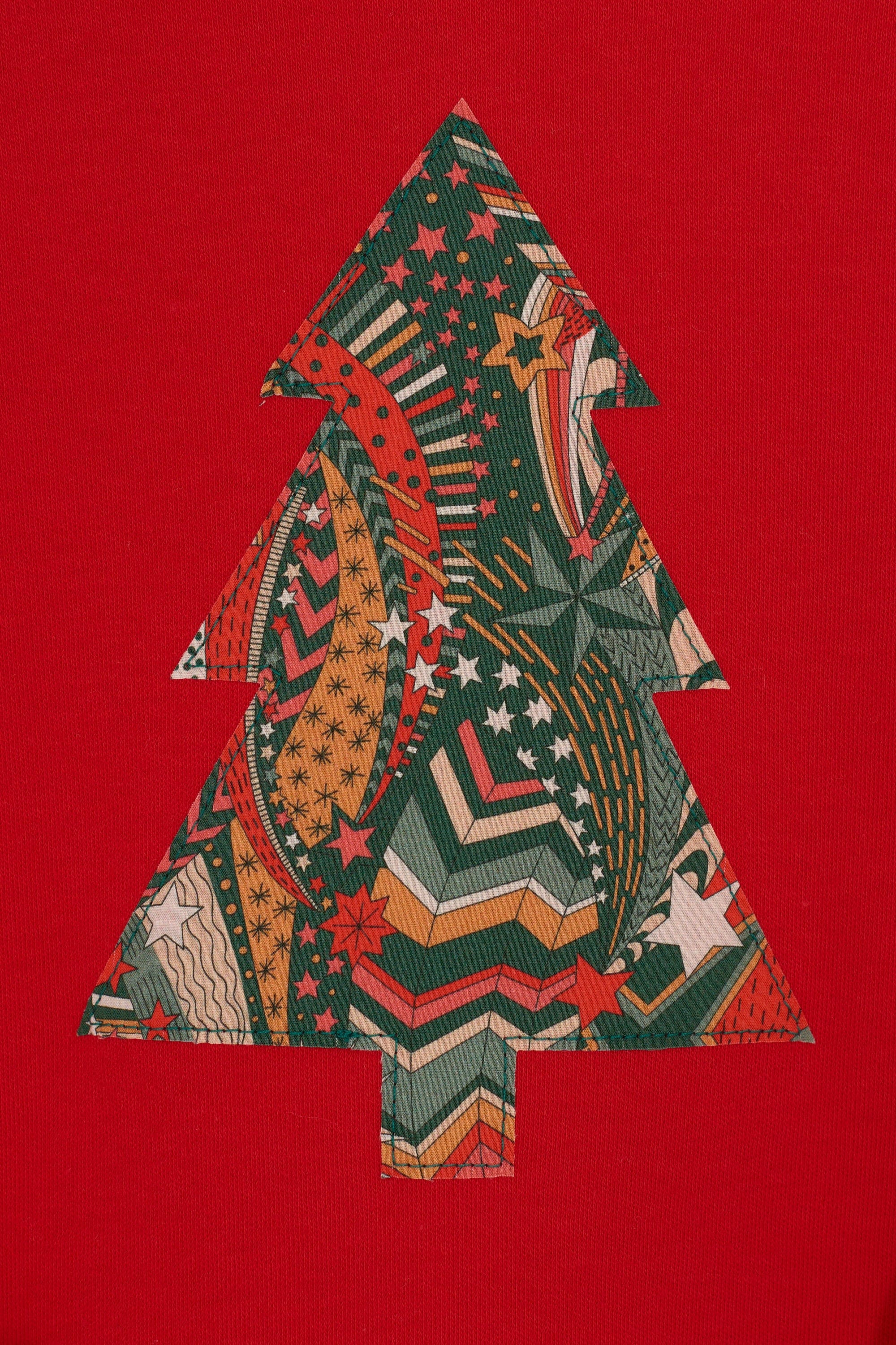 A festive red cotton t-shirt with a Christmas tree made from a stray liberty print on the front.