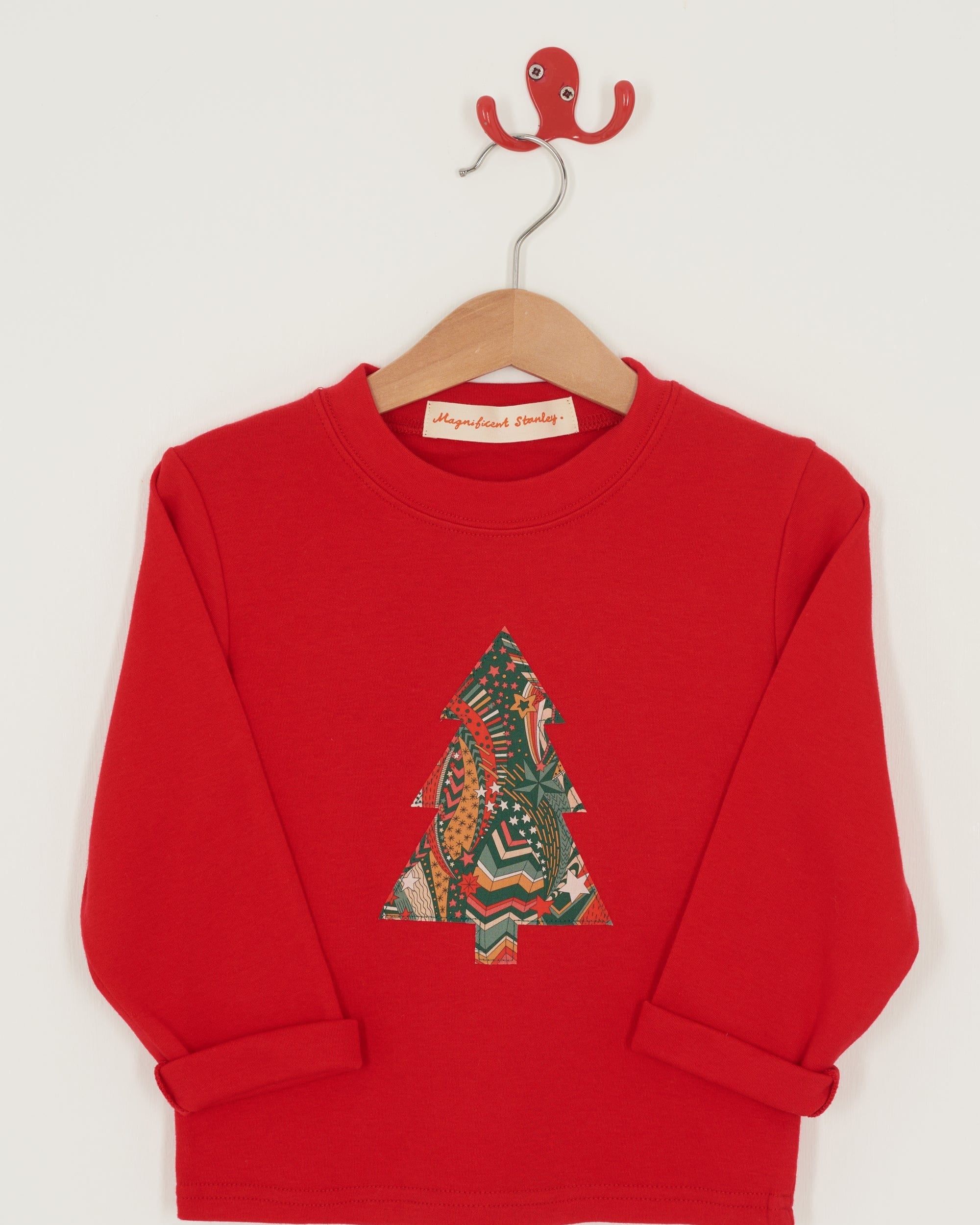 A festive red cotton t-shirt with a Christmas tree made from a stray liberty print on the front.