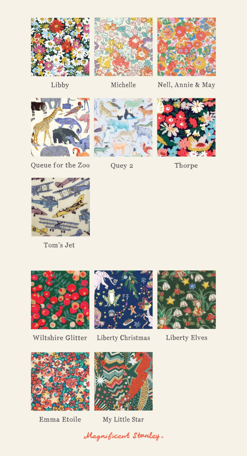 A grid of 24 liberty print fabric swatches with colourful patterns and names underneath, including Adelajda Brown, Besty Ann, Capel Mustard, and others, on a light beige background. The brand name 'Magnificent Stanley' appears at the bottom. Patterns feature cars, planes, flowers, balloons, dinosaurs, stars and cats.