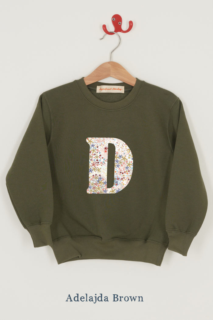 a personalised khaki sweater with a large letter 'D' in Adelajda liberty starry print.