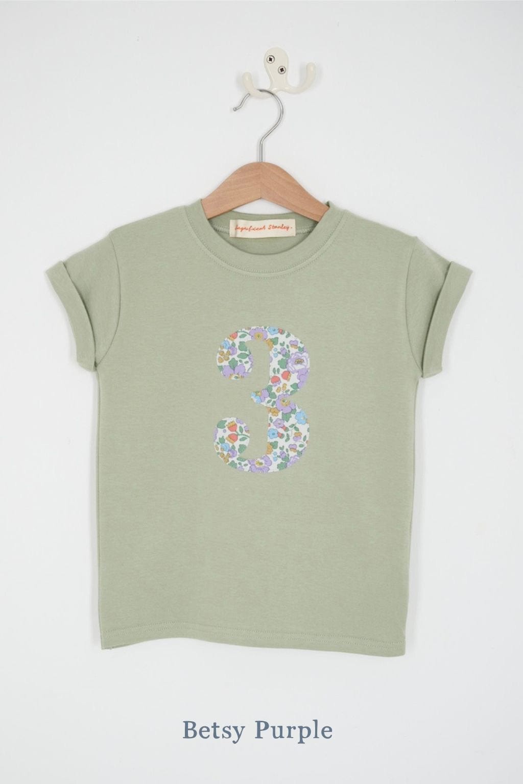 a number 3rd birthday kids sage green t-shirt with a number cut from betsy purple floral liberty print on the front.