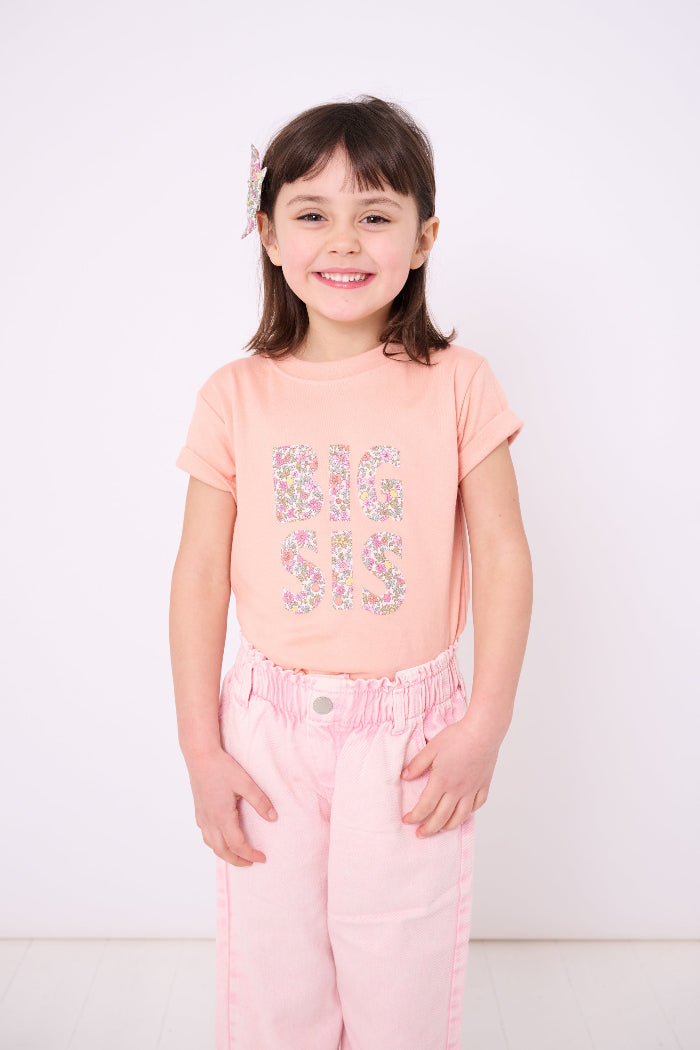 A girl wearing a BIG SIS pale Pink T-Shirt in Choice of Liberty Print as a proud big sister