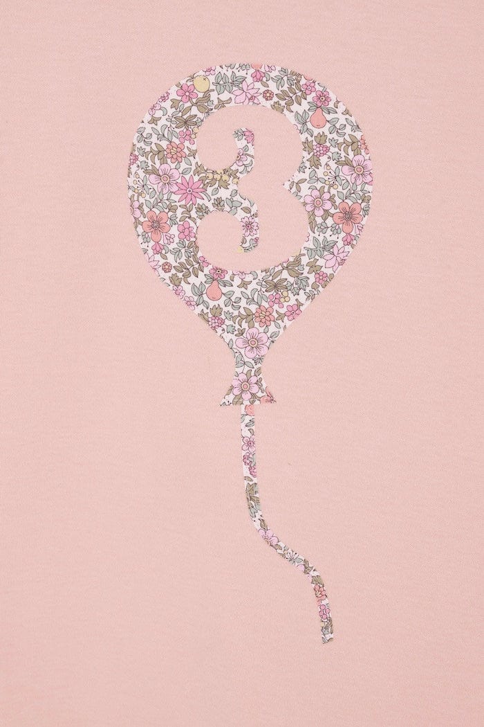 a pink birthday t-shirt with a balloon with the number 3 on it cut from floral Liberty print.