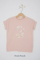 a pink 3rd birthday t-shirt with a number 3 cut from  fruit punch liberty floral print on the front
