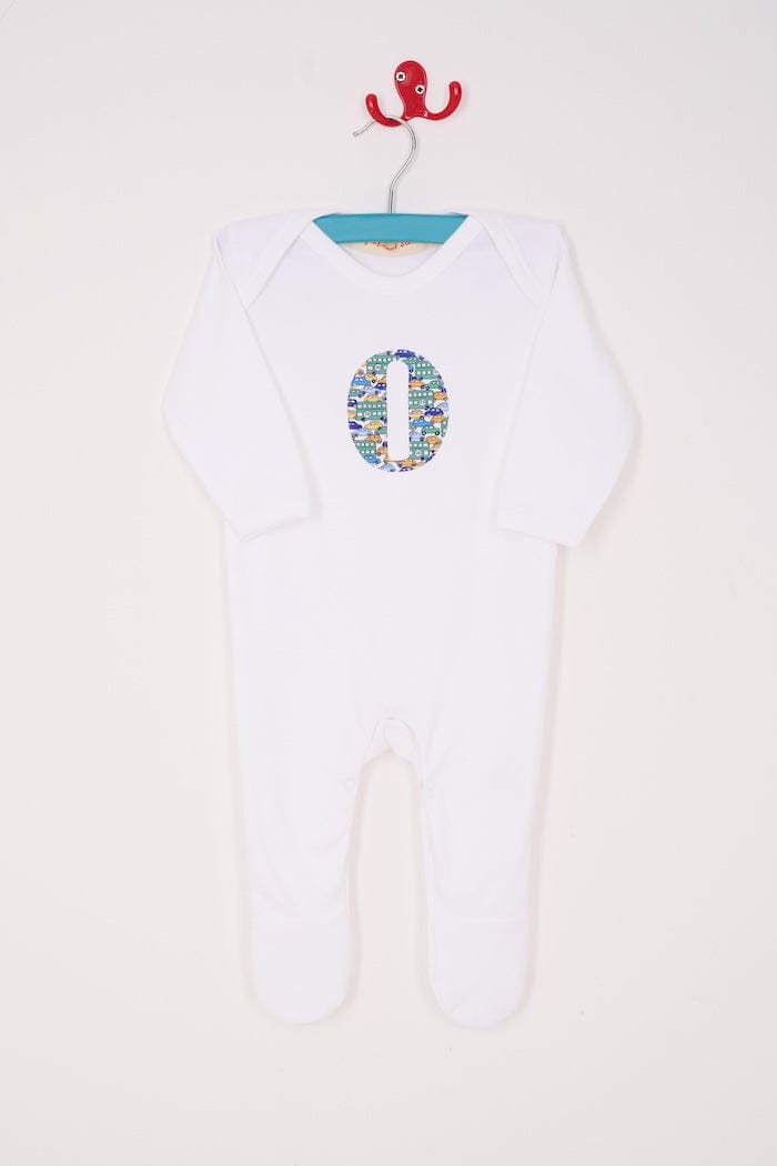 a personalised cotton baby romper with his initial on the front in hop on hop off liberty print featuring cars and London buses.