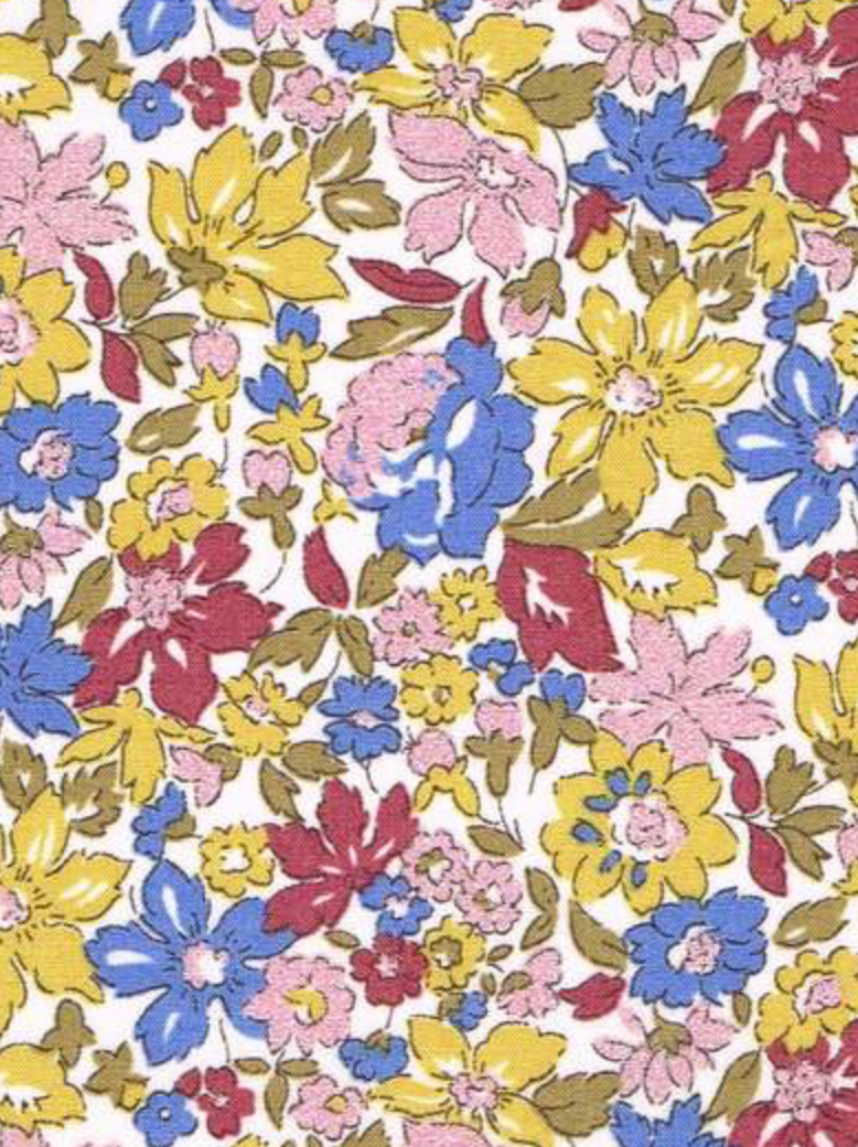 A close-up of a floral patterned Liberty Julia Belle fabric  featuring large yellow, blue, pink sparkle, and red flowers with olive green leaves on a white background.