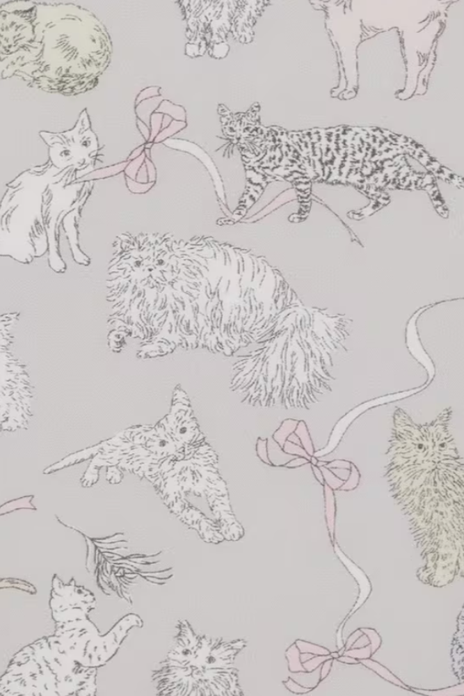 A repeating pattern of illustrated cats and bows on a light gray background, with the cats drawn in pale pink, cream, and gray line art.