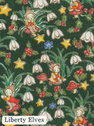 A repeating pattern of Liberty Elves fairies in red dresses among white snowdrops, red berries, green holly leaves, yellow stars, and red-and-white mushrooms on a dark green background. The text 'Liberty Elves' appears in a white rounded rectangle at the bottom left.