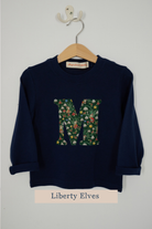 a navy cotton t-shirt with the letter 'c' on the front cut from festive Liberty Elves liberty print