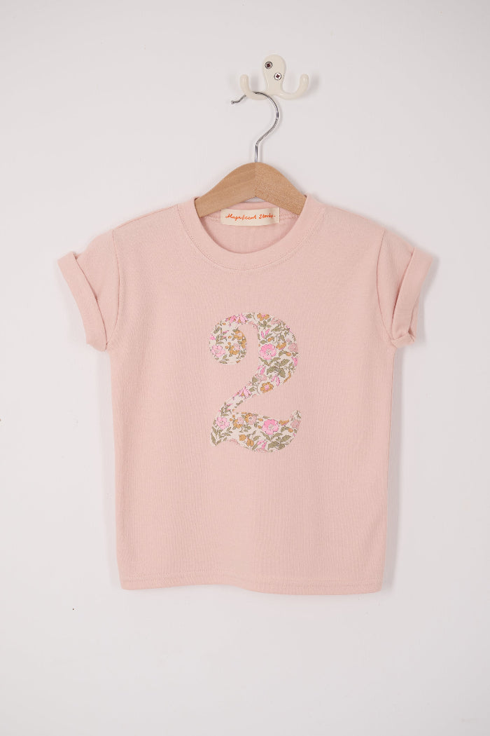 a pale pink t-shirt with the number 2 sewn on the front cut from liberty floral Mamie print.
