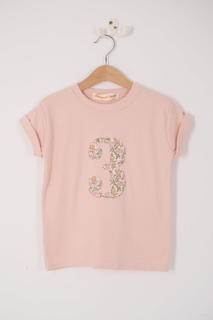 a pale pink t-shirt with the number 3 sewn on the front cut from liberty floral Mamie print.