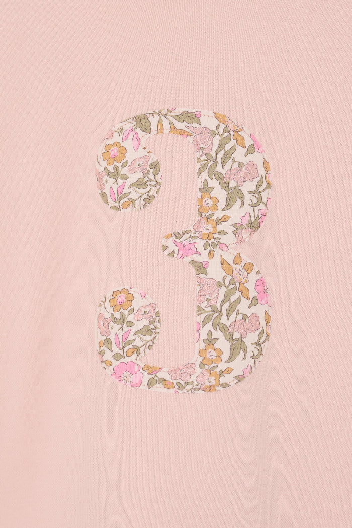 a pale pink t-shirt with the number 3 sewn on the front cut from liberty floral Mamie print.