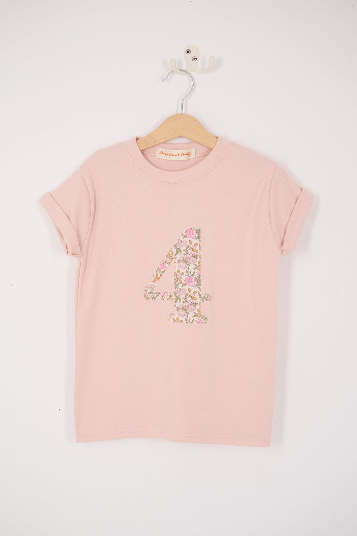 a pale pink t-shirt with the number 4 sewn on the front cut from liberty floral Mamie print.