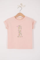 a pale pink t-shirt with the number 1 sewn on the front cut from liberty floral Mamie print.