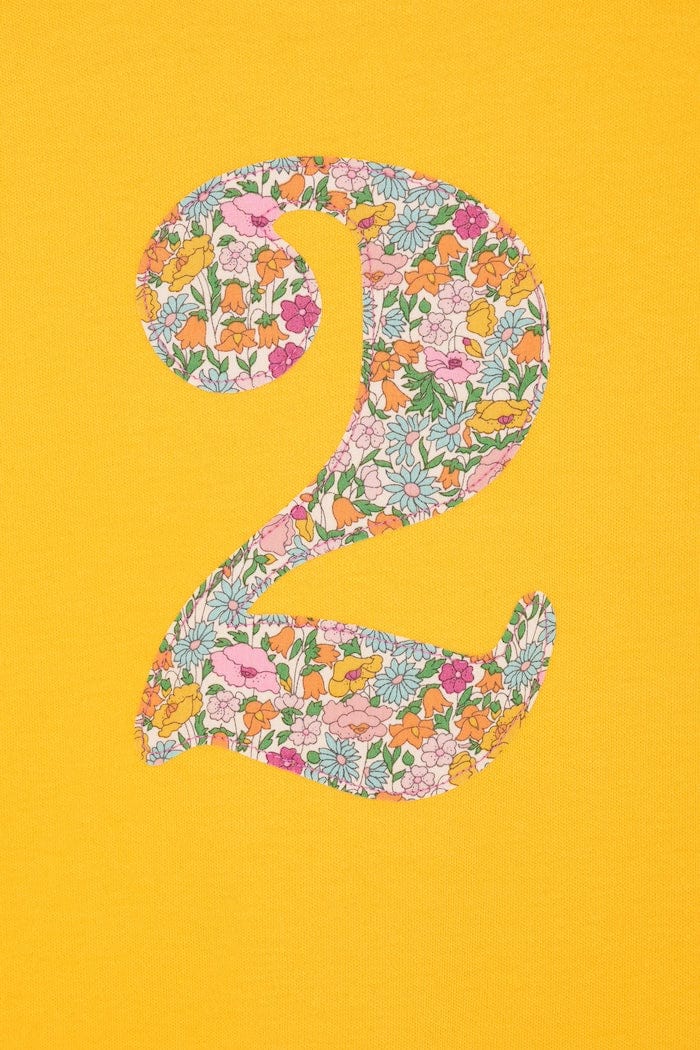 a yellow birthday t-shirt with a number 2 cut from liberty floral print on the front
