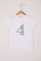 A white cotton t-shirt with the number 4 sewn on the front cut from liberty Quey 2 zoo animal print.