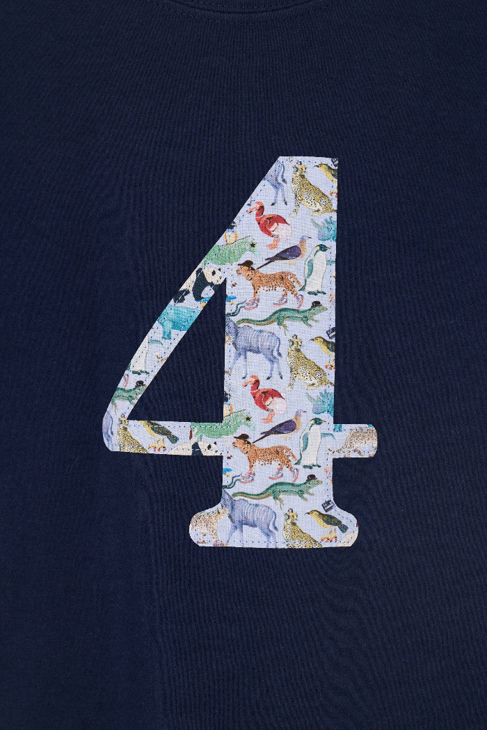 A close up of a navy cotton t-shirt with the number 4 sewn on the front cut from liberty Quey 2 zoo animal print.
