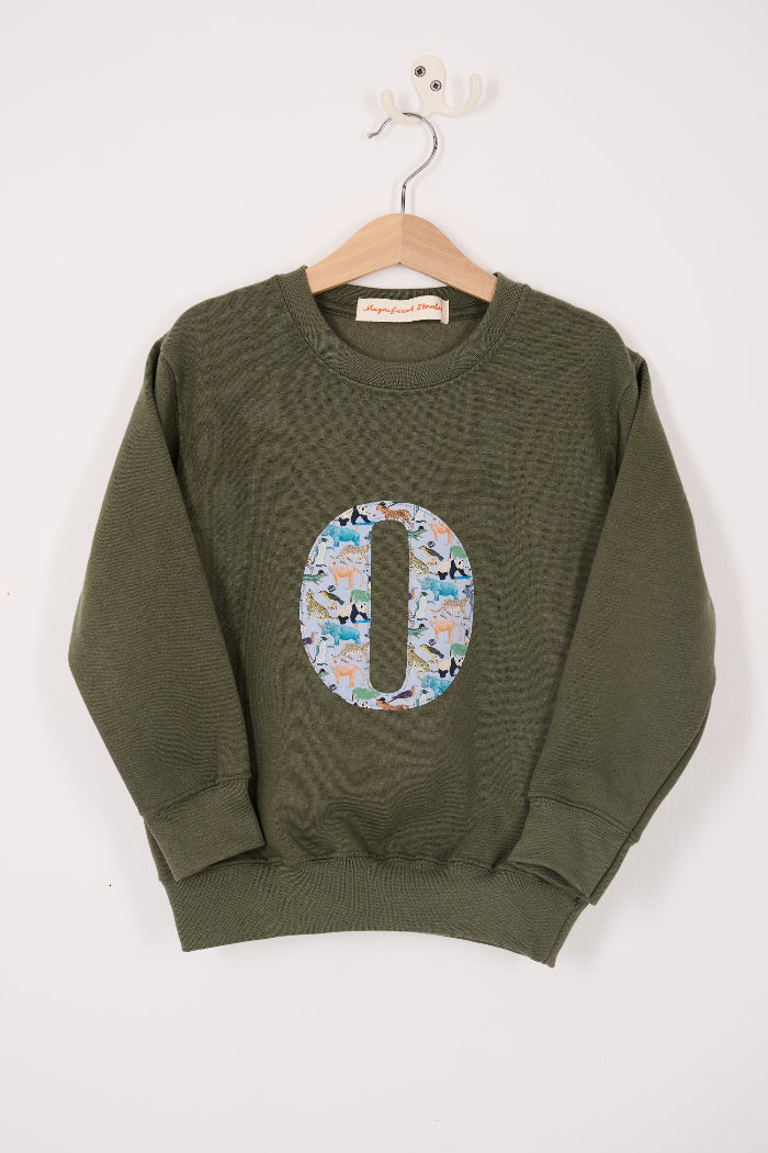 a personalised khaki sweater with a large letter 'O' in Quey 2 liberty animal print.