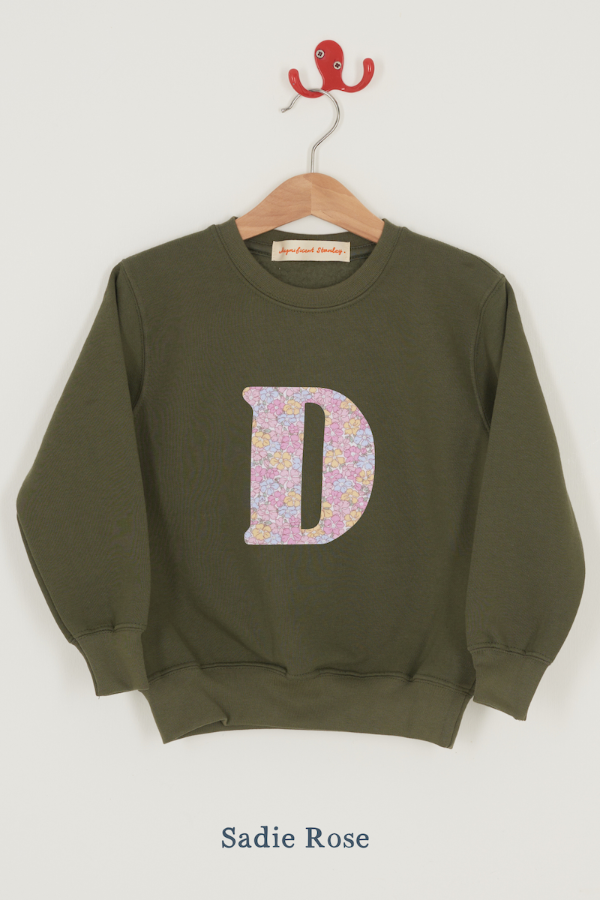 a personalised khaki sweater with a large letter 'D' in sadie rose liberty floral print.