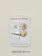 Two star print hair clips on a 'Magnificent Stanley' branded card in Adelajda Brown print