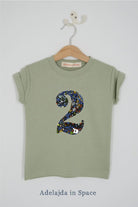 a birthday number 2 kids sage green t-shirt with a number cut from adelaide in space liberty print on the front.