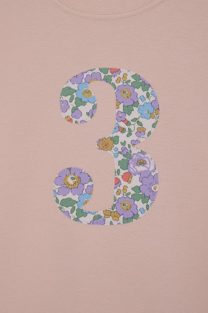 a pink birthday t-shirt with a number 3 cut from betsy purple liberty floral print on the front