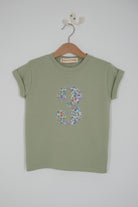  a sage green birthday t-shirt with a number 3 cut from liberty floral betsy purple print on the front