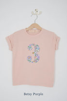 a pink birthday t-shirt with a number 3 cut from betsy purple liberty floral print on the front