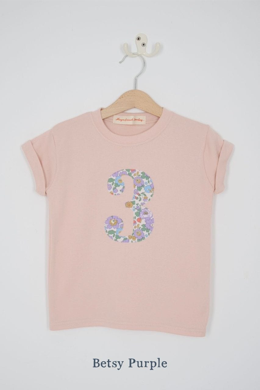a pink birthday t-shirt with a number 3 cut from betsy purple liberty floral print on the front