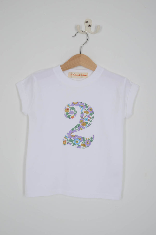 a white birthday t-shirt with a number 2 cut from betsy purple liberty floral print on the front