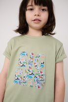 Child wearing a 'Big Bro' green t-shirt with animal-themed letters on a plain background