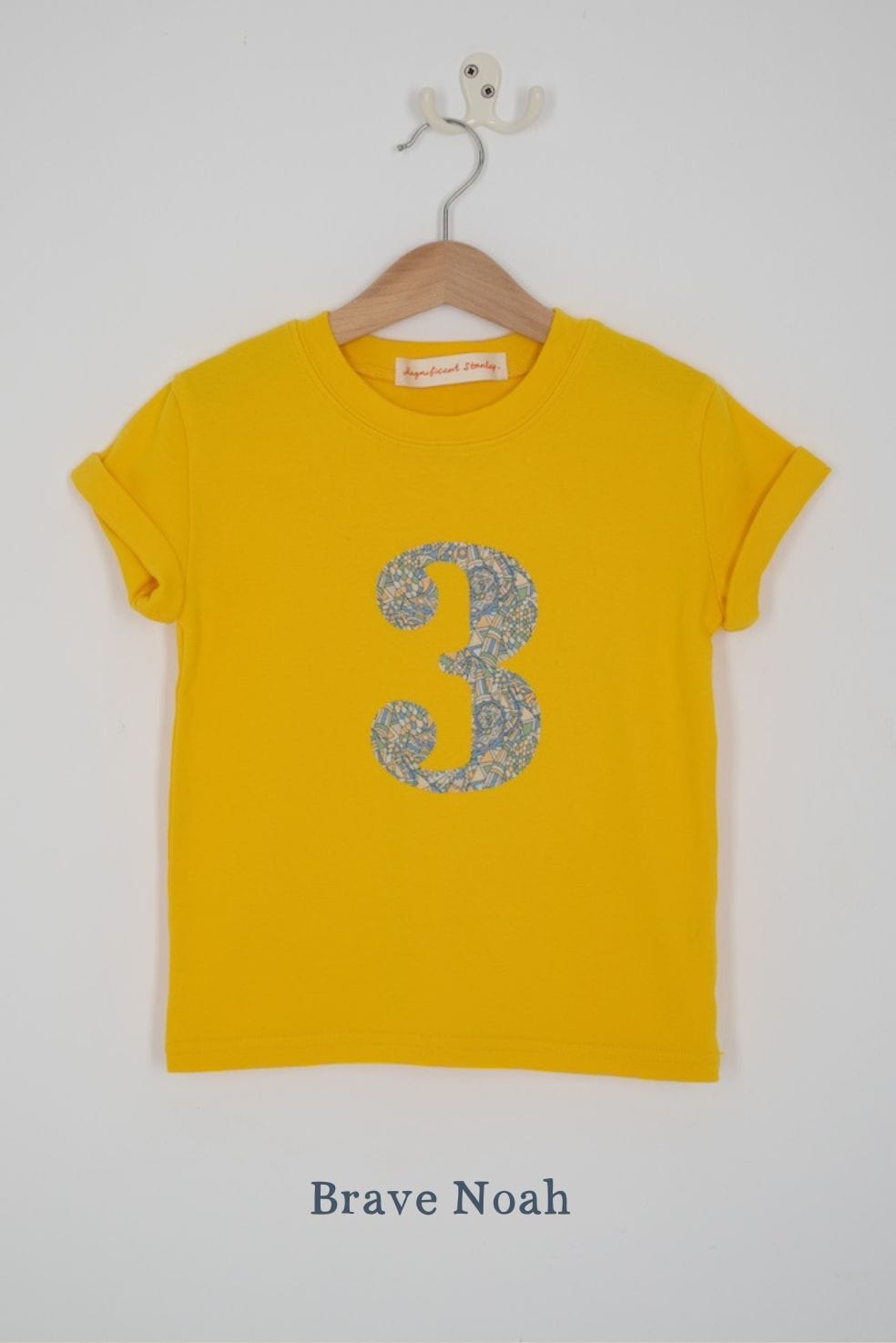 a yellow birthday t-shirt with a number 3 cut from brave noah liberty print on the front.