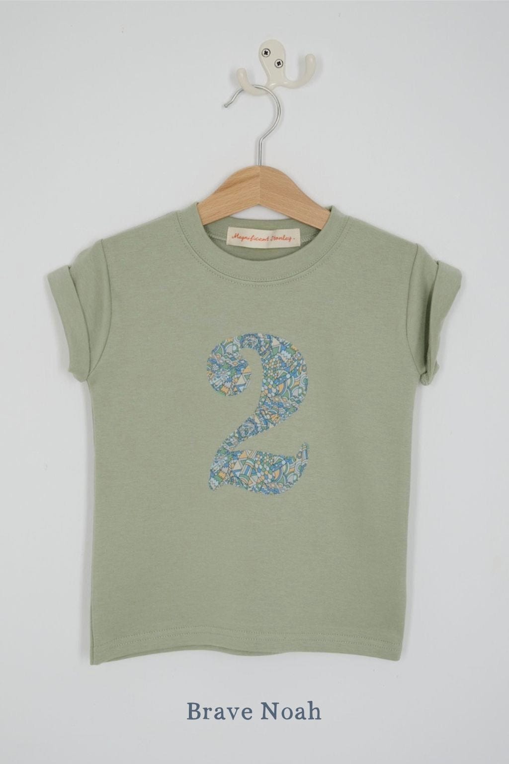 a number 2nd birthday kids sage green t-shirt with a number cut from brave noah dragon liberty print on the front.