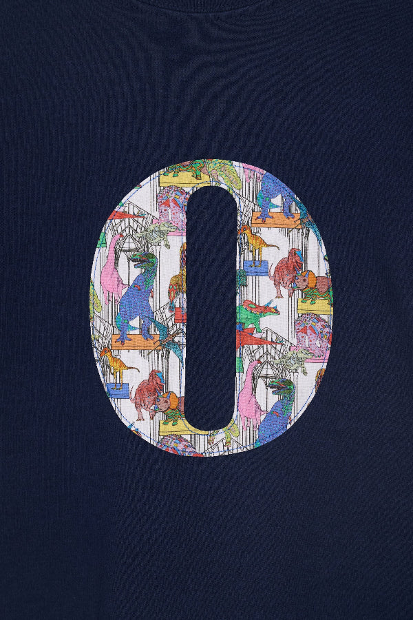 a  close up of the stitching on a navy kids personalised t-shirt with a colourful number 4 design in Liberty dinosaur print on the front